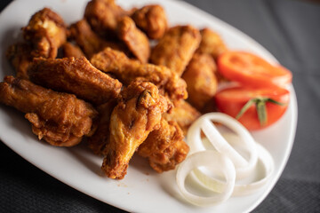 Hot chicken wings with honey and parmeisane cheese