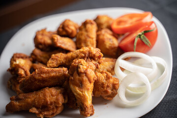 Hot chicken wings with honey and parmeisane cheese