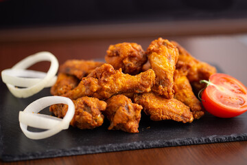 Hot chicken wings with honey and parmeisane cheese