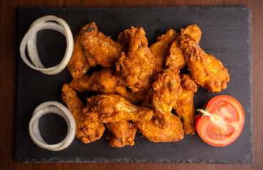 Hot chicken wings with honey and parmeisane cheese