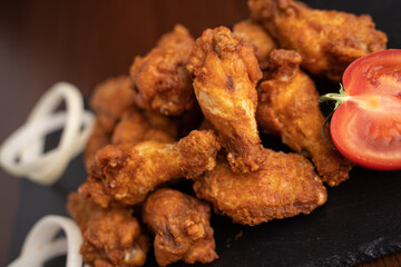 Hot chicken wings with honey and parmeisane cheese