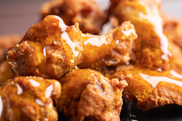 Hot chicken wings with honey and parmeisane cheese