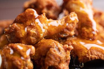 Hot chicken wings with honey and parmeisane cheese