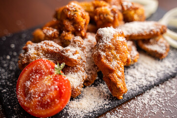 Hot chicken wings with honey and parmeisane cheese