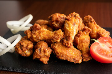 Hot chicken wings with honey and parmeisane cheese