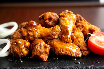 Hot chicken wings with honey and parmeisane cheese