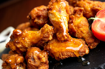 Hot chicken wings with honey and parmeisane cheese