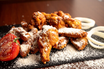 Hot chicken wings with honey and parmeisane cheese