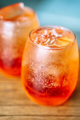 Cold cocktail. Summer soft drink with ice based on orange juice and syrup in a glass.