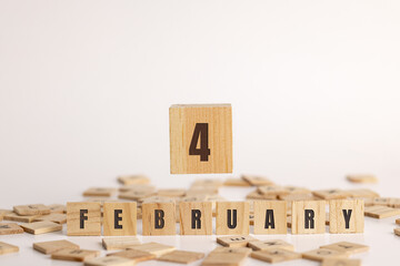 February 4 displayed wooden letter blocks on white background with room for print