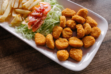 Croquetas de pollo con ensalada y papas a la francesa 