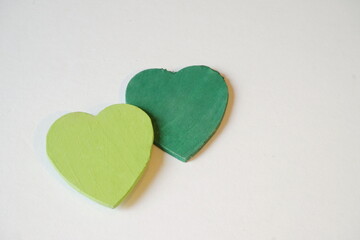 Obraz premium Dark Green and Overlapping Light Green Heart on White with Room for Text