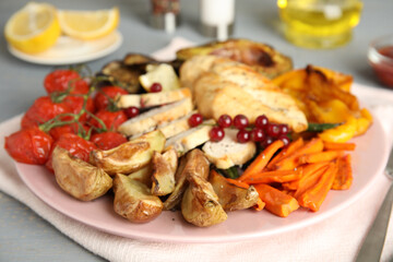 Tasty cooked chicken fillet and vegetables served on table. Healthy meals from air fryer