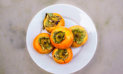 Persimmons from California are being packed. The fruit is grown naturally and harvested while the flesh is still firm, shipping in short time is not a problem. Some persimmons are non astringent, 