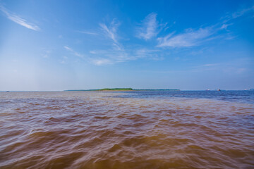 View of the The Meeting of Waters, the confluence between the dark Rio Negro and the pale Solimoes...