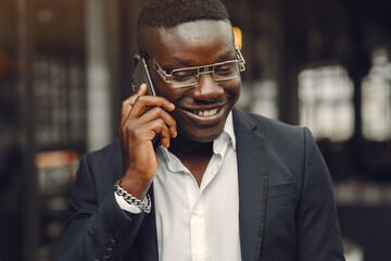 Handsome african man in a black suit at the office