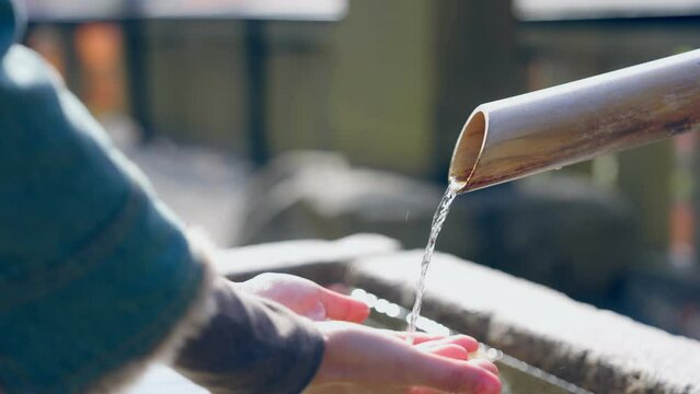 Shrine's innermost grounds is a place to purify the body before entering. Here worshippers wash their hands and mouth, flowing water in an act of ritual purification