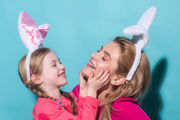 Ester for mother and daughter. Daughter kiss her mother for Easter, isolated. Horizontal photo...
