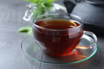 Fresh tea with mint on grey table, closeup