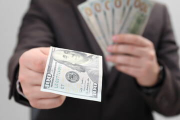 Man holding money on white background, closeup. Currency exchange