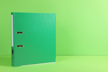 Office folder on light green background, space for text