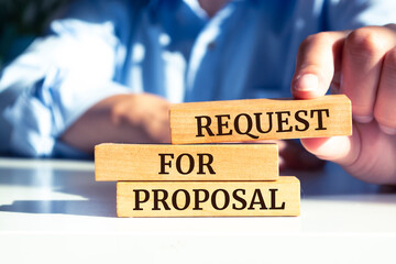 Closeup on businessman holding a wooden block with "Request for proposal", Business concept