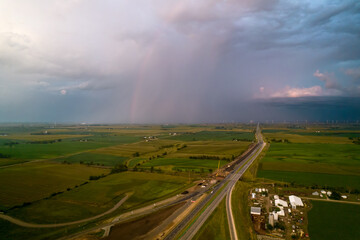 Aerial view of landscape after rain, rainbow in clouds