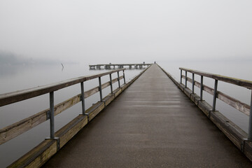 Dock surrounded by heavy fog in winter in Bothell, WA
