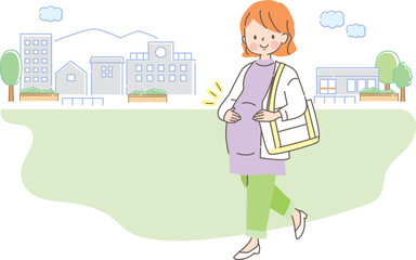 街の中を散歩する笑顔の妊婦さん