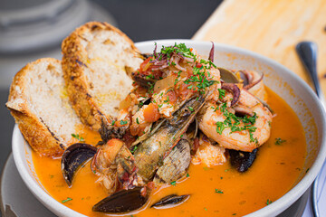 Stew with seafood from Italy. Clams, mussels, squids, and shrimp are cooked in a tomato sauce with cheeses and herbs. To increase the savory, Calabrian chilis are added. Dip with bread.