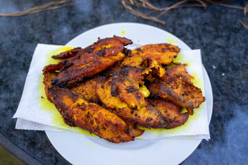 Fried fish with lemongrass and chilli peppers. Tilapia fish fillets are cleaned, dried, then fermented with lemongrass, salt, sugar, turmeric and chilli pepper. Give them an hour to marinate thoroughl