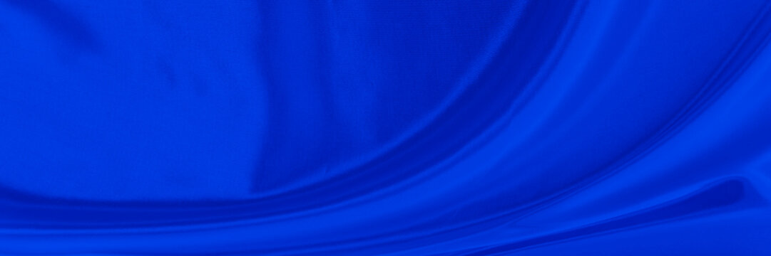 Black blue satin dark fabric texture luxurious shiny that is abstract silk cloth background with patterns soft waves blur beautiful.
