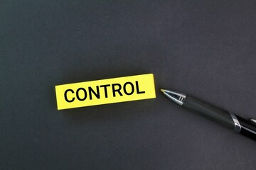 yellow pen and paper with the word control. the concept of control in the area or price control.