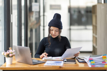 Business freelance Asian woman working at office with documents on her desk, doing planning analyzing the financial report, business plan investment, finance analysis concept