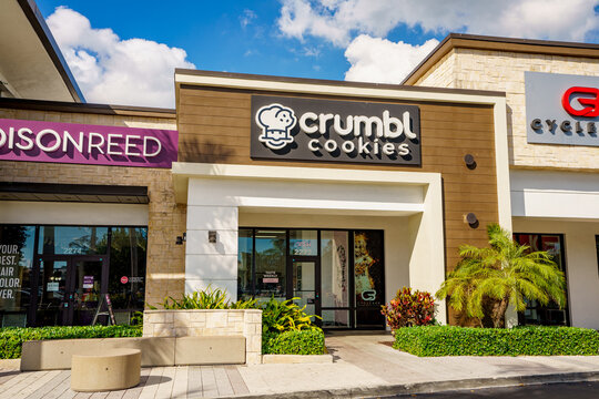 Photo of shops and restaurants at Tower Shops outdoor mall Davie Florida. Crumbl cookies