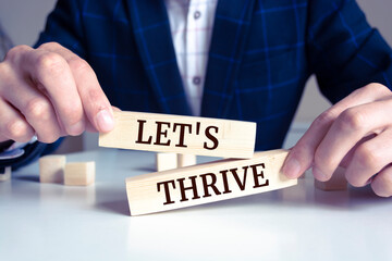 Obraz premium Closeup on businessman holding a wooden block with 