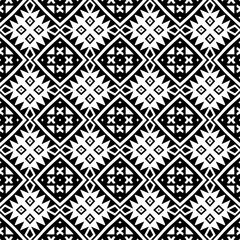 Seamless pattern of black shapes on white background.