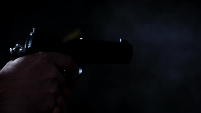 Handgun shooting multiple times in a dark room