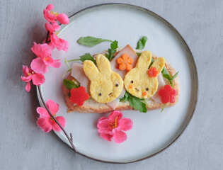 Eating light and healthy during the holiday seasons. Animated Rabbit Shape Omelette Ham and Sourdough Bread Breakfast. Festive food arrangements