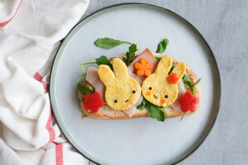 Eating light and healthy during the holiday seasons. Animated Rabbit Shape Omelette Ham and Sourdough Bread Breakfast. Festive food arrangements