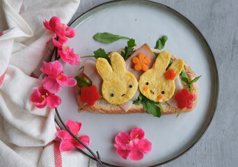 Eating light and healthy during the holiday seasons. Animated Rabbit Shape Omelette Ham and Sourdough Bread Breakfast. Festive food arrangements
