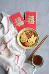 Festive seasons approaching, eating light and healthy meals. Prosperity Animated Rabbit Shape Breakfast. The Chinese characters in the red packet translated to wealth and luck