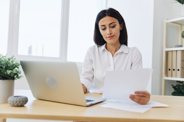 Woman business working at her laptop at home in her office, freelance employee in business, happiness of working online, technology in business