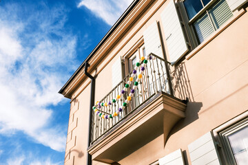 Window Balcony on the Corner of a Modern Home Decorated with Mardi Gras beads