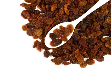 Raisins on a white background. Spoon with raisins. Sweet dried raisins.
