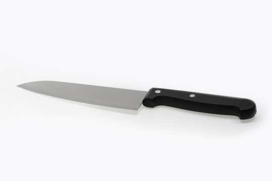 Image of a cooking knife with the handle in the foreground on a white background