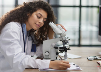 Female scientist researcher conducting an experiment in a labora