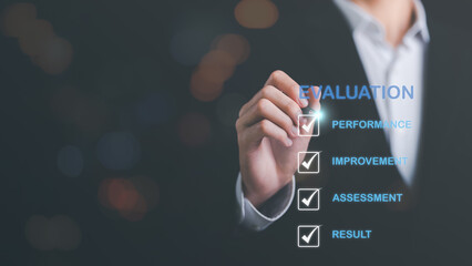 Businessman using a pen to point at an icon,result evaluation concept,plan review through professional analysis,review and rating to evaluate past performance,for the best performance and quality