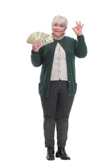 Portrait of happy aged woman holding money and pointing