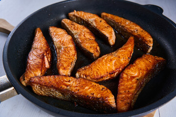 Salmon fillets in the frying pan